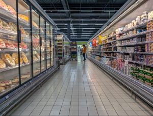 Client faisant ses courses dans un rayon de supermarché français